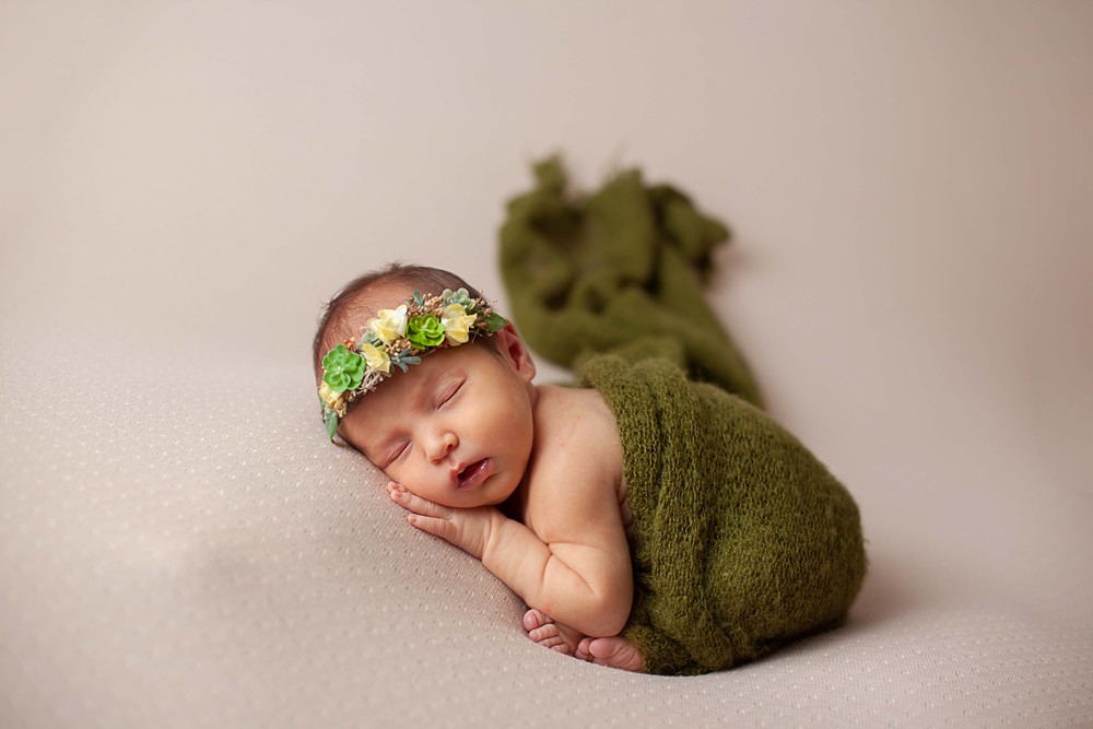 When considering which newborn photographer to hire; look at their photography style and be sure it's something you like.