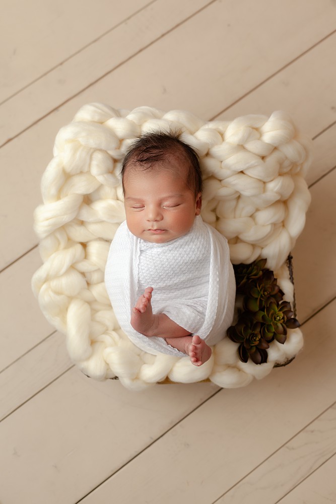Thick chunky knitted blankets add an interesting visual aesthetic to any newborn portrait.