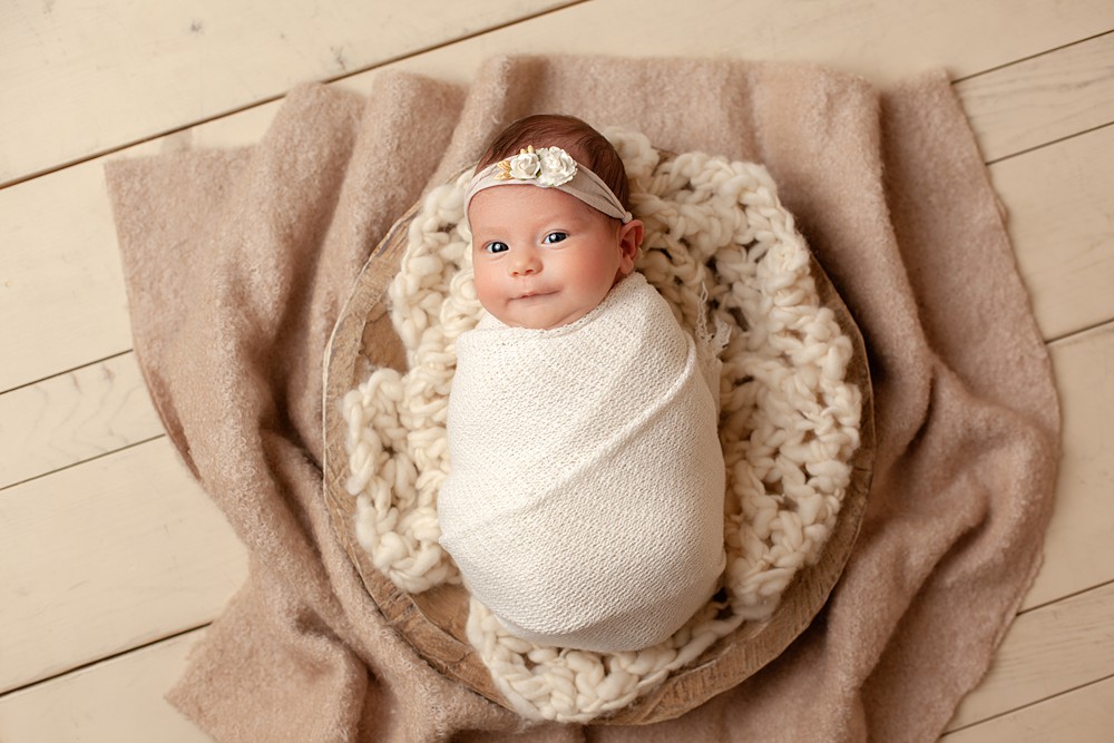 Blankets add visual purpose as well as comfort in a newborn portrait.