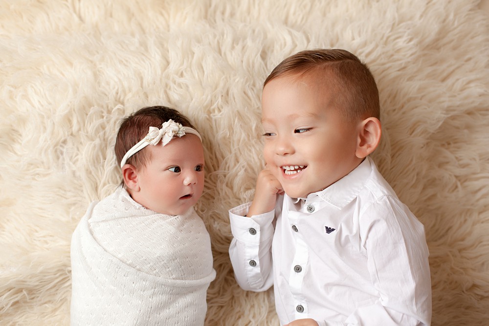 Newborn portraits with young siblings can be tricky but are completely doable with a little patience!