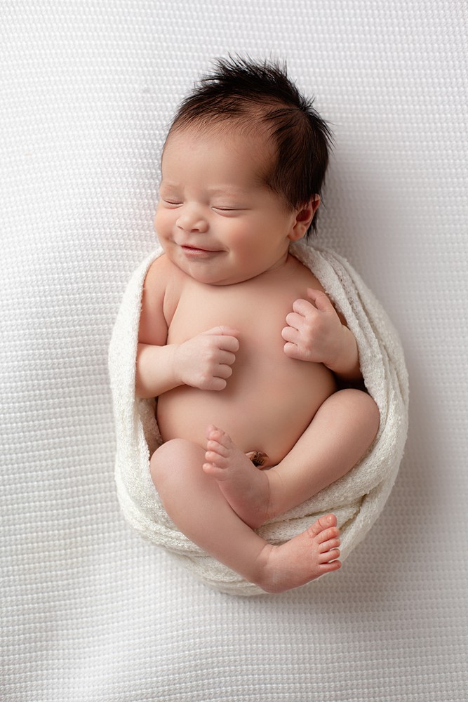 A professional newborn photographer will never put a newborn in a compromising position. 