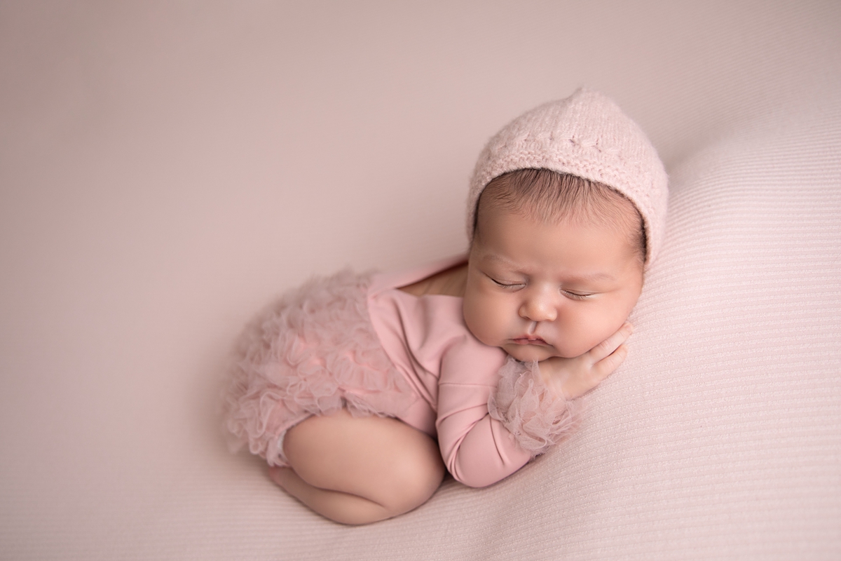 Newborn girl posed in bum up pose for newborn photographers