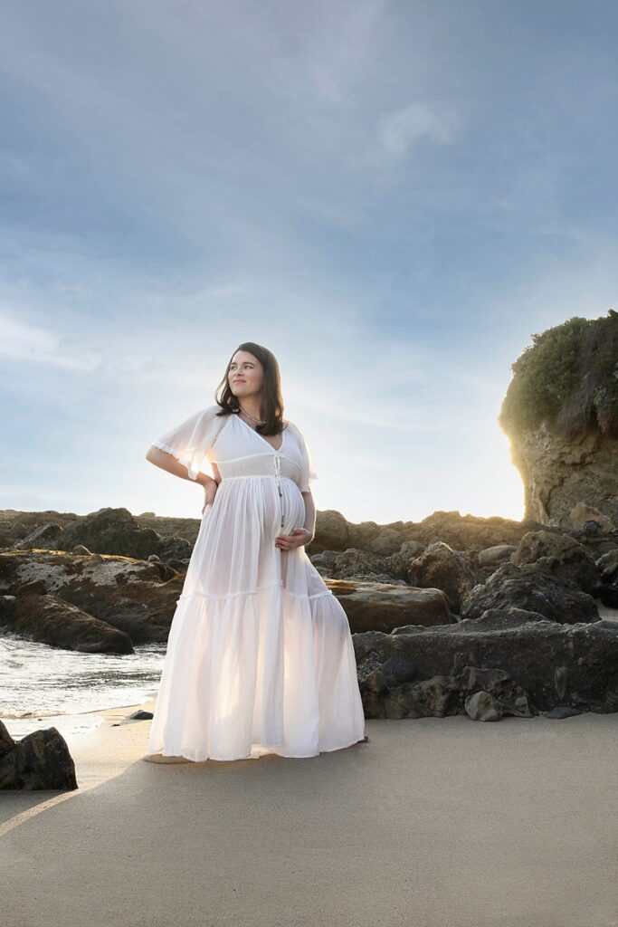 Pregnant women at Laguna Beach California wearing a boho dress