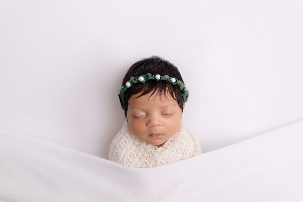 newborn girl wrapped by a Westminster Baby Photographer