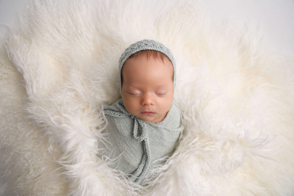 Newborn Boy wrapped in blue in Westminster as a Newborn Photographer 