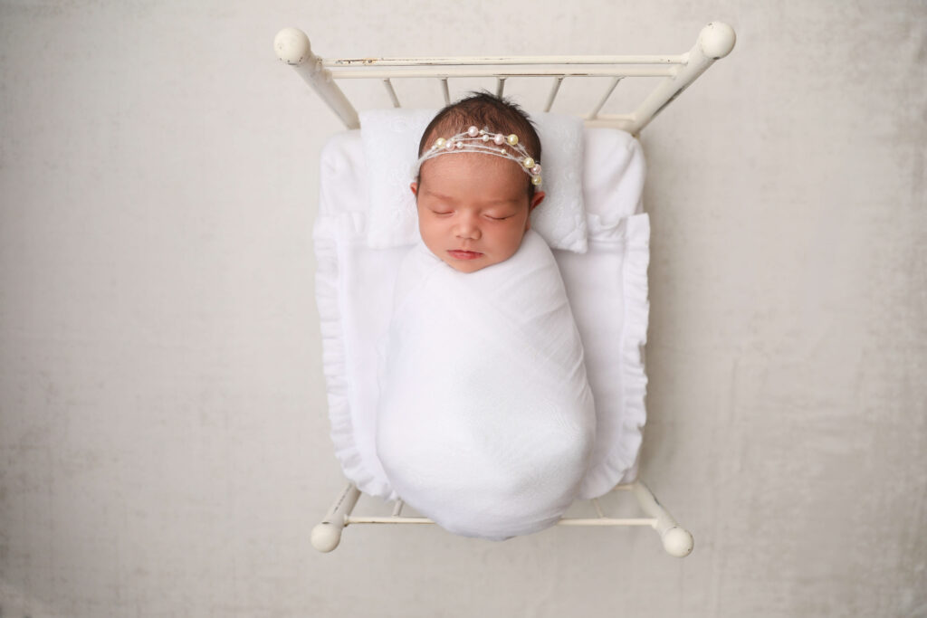 Newborn Bed with a girl in at Huntington Beach as a Photographer