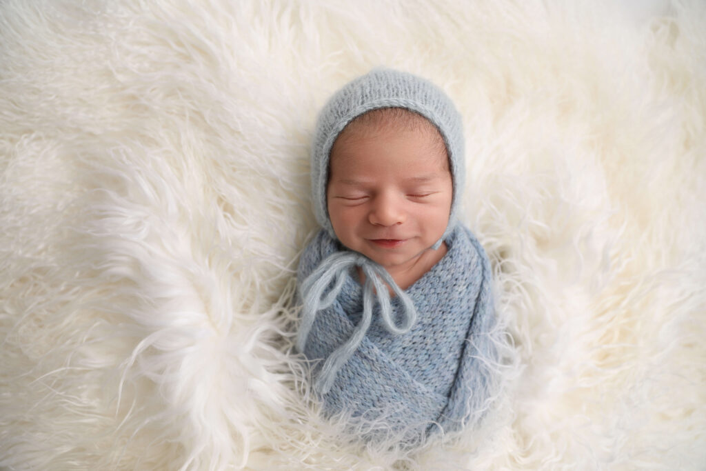 newborn boy smiling in  Lake Forest  by a Newborn Photographer