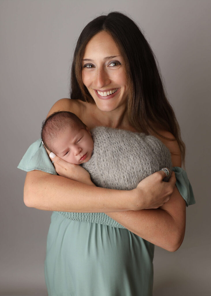 Mom and baby boy together captured by a Lake Forest Newborn Photographer