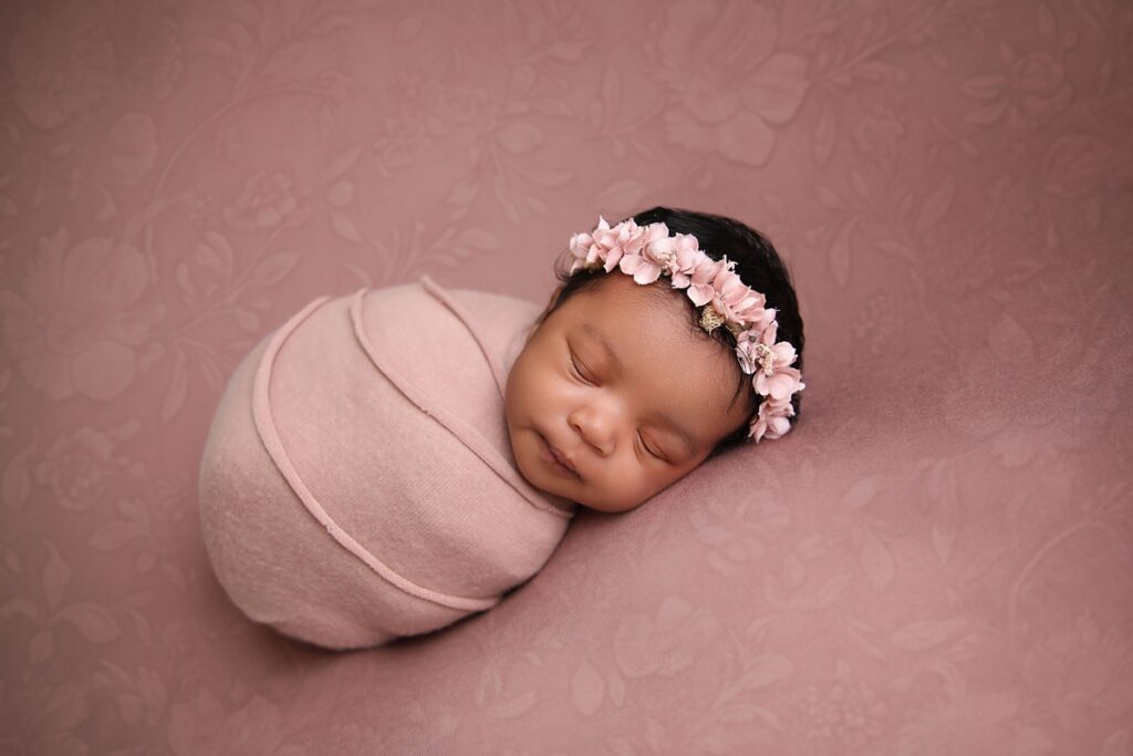 Newborn Girl in pink swaddled up at her Long Beach Newborn Photoshoot